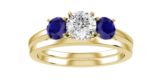 Yellow gold engagement ring with round diamond center stone and round blue sapphire side stones.